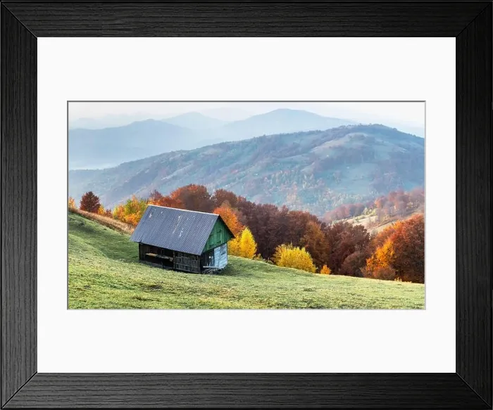 Framed Print : Old wooden house on green meadow in Carpathian mountains. Multicolored autumn trees on background. Landscape photography Framed Print : Old wooden house on green meadow in Carpathian mountains. Multicolored autumn trees on background. Landscape photography
