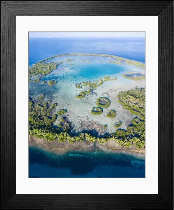 Framed Print : A remote tropical island in the Molucca Sea is fringed by mangrove forest surrounding a shallow lagoon. This island sits amid the Coral Triangle Framed Print : A remote tropical island in the Molucca Sea is fringed by mangrove forest surrounding a shallow lagoon. This island sits amid the Coral Triangle