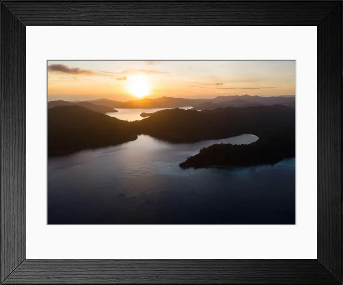 Framed Print : Dawn illuminates remote islands and the surrounding calm waters in Raja Ampat, Indonesia. This region is the epicenter of marine biodiversity Framed Print : Dawn illuminates remote islands and the surrounding calm waters in Raja Ampat, Indonesia. This region is the epicenter of marine biodiversity