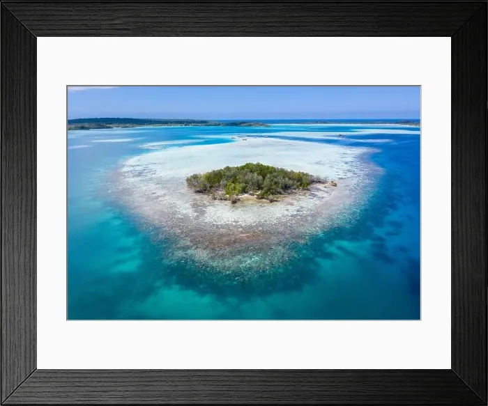 Framed Print : A remote, tropical island in the Molucca Sea, Indonesia, is surrounded by a healthy coral reef. This region is home to incredible marine biodiversity Framed Print : A remote, tropical island in the Molucca Sea, Indonesia, is surrounded by a healthy coral reef. This region is home to incredible marine biodiversity
