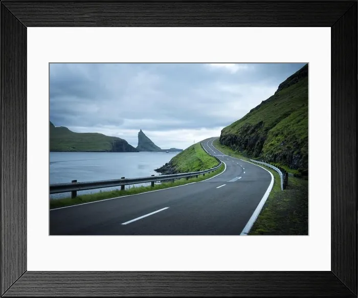 Framed Print : Dramatic evening view of the road and the Drangarnir and Tindholmur rocks in the background on the island of Vagar, Faroe Islands, Denmark Framed Print : Dramatic evening view of the road and the Drangarnir and Tindholmur rocks in the background on the island of Vagar, Faroe Islands, Denmark