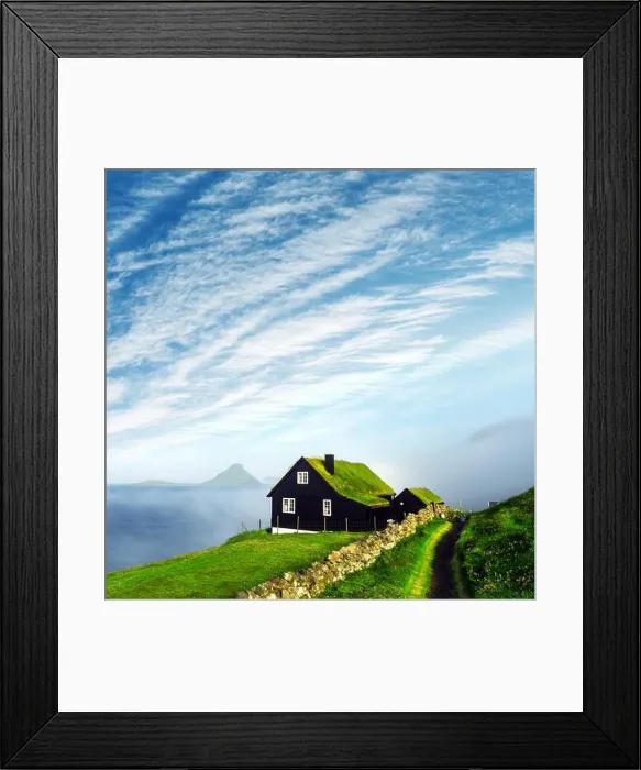 Framed Print : Foggy morning view of a house with typical turf-top grass roof and blue cloudy sky in the Velbastadur village on Streymoy island, Faroe islands Framed Print : Foggy morning view of a house with typical turf-top grass roof and blue cloudy sky in the Velbastadur village on Streymoy island, Faroe islands