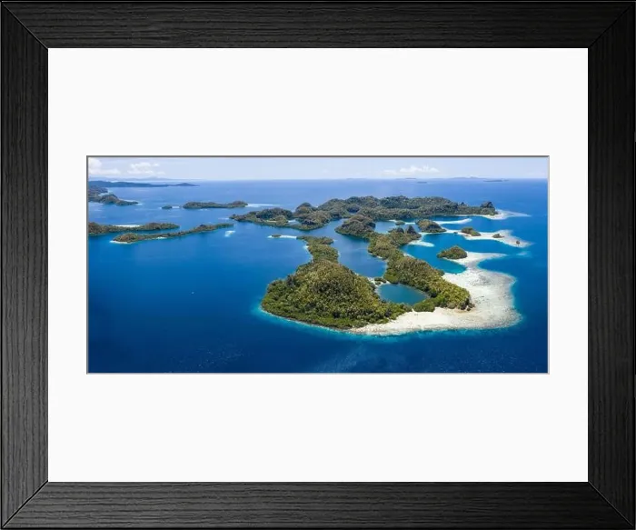 Framed Print : Forest-covered limestone islands rise from the seascape in Raja Ampat, Indonesia. This remote region is known for its great marine biodiversity Framed Print : Forest-covered limestone islands rise from the seascape in Raja Ampat, Indonesia. This remote region is known for its great marine biodiversity