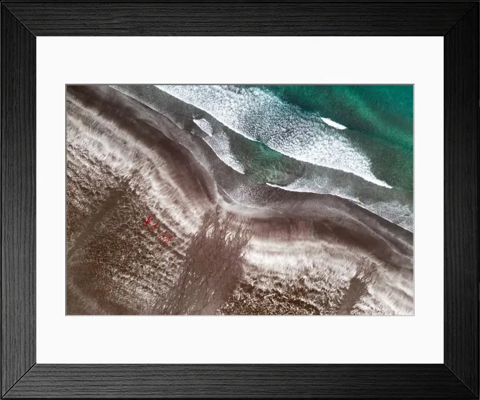 Framed Print : Aerial view of black sand beach and ocean waves. Red kayaks ready for swimming Framed Print : Aerial view of black sand beach and ocean waves. Red kayaks ready for swimming