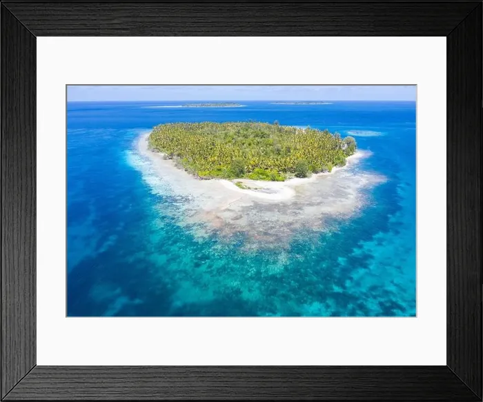 Framed Print : A remote island is found amid the serene seascape in Raja Ampat, Indonesia. This tropical region is a large part of the Coral Triangle Framed Print : A remote island is found amid the serene seascape in Raja Ampat, Indonesia. This tropical region is a large part of the Coral Triangle