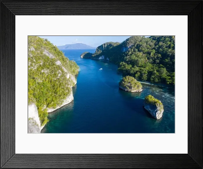 Framed Print : Limestone islands are surrounded by healthy coral reefs in Raja Ampat, Indonesia. This region is thought to be the epicenter of marine bodiversity Framed Print : Limestone islands are surrounded by healthy coral reefs in Raja Ampat, Indonesia. This region is thought to be the epicenter of marine bodiversity