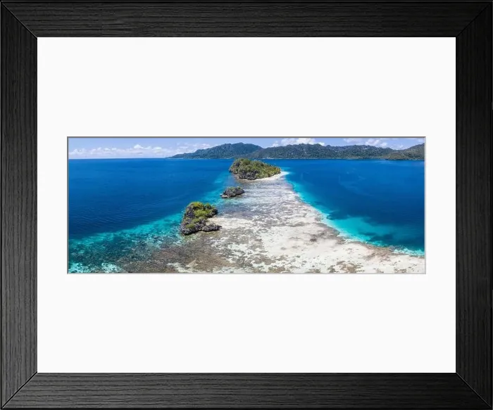 Framed Print : Limestone islands are surrounded by healthy coral reefs in Raja Ampat, Indonesia. This region is thought to be the epicenter of marine bodiversity Framed Print : Limestone islands are surrounded by healthy coral reefs in Raja Ampat, Indonesia. This region is thought to be the epicenter of marine bodiversity