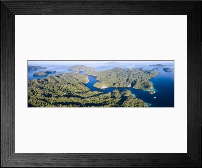 Framed Print : Limestone islands covered by forest lie scattered amid Raja Ampat, Indonesia. This region is thought to be the epicenter of marine bodiversity Framed Print : Limestone islands covered by forest lie scattered amid Raja Ampat, Indonesia. This region is thought to be the epicenter of marine bodiversity