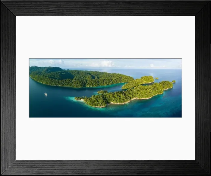 Framed Print : Beautiful tropical islands, surrounded by reefs, rise from West Papua's seascape. This area is known for its marine biodiversity