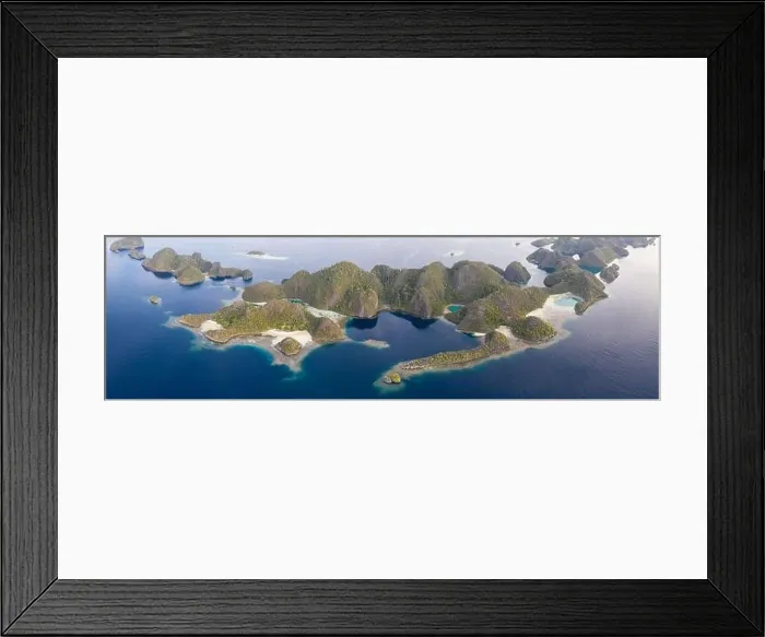 Framed Print : Limestone islands are surrounded by healthy coral reefs in Raja Ampat, Indonesia. This region is thought to be the center of marine biodiversity Framed Print : Limestone islands are surrounded by healthy coral reefs in Raja Ampat, Indonesia. This region is thought to be the center of marine biodiversity