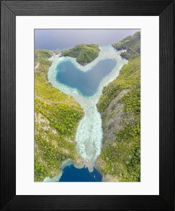 Framed Print : Healthy coral reefs surround a heart-shaped lagoon in Raja Ampat, Indonesia. This amazing tropical region is famous for its high marine biodiversity Framed Print : Healthy coral reefs surround a heart-shaped lagoon in Raja Ampat, Indonesia. This amazing tropical region is famous for its high marine biodiversity
