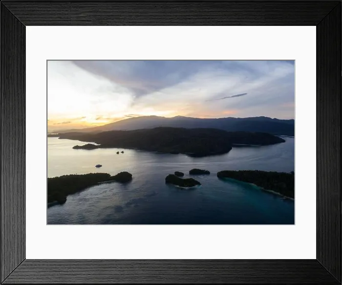 Framed Print : A peaceful sunrise illuminates the remote, tropical islands scattered through Raja Ampat, Indonesia. This area is known for its high biodiversity Framed Print : A peaceful sunrise illuminates the remote, tropical islands scattered through Raja Ampat, Indonesia. This area is known for its high biodiversity