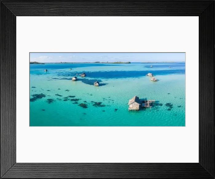 Framed Print : A bird's eye view shows a rustic Indonesian fishing village constructed on a coral reef near remote, tropical islands in the Halmahera Sea Framed Print : A bird's eye view shows a rustic Indonesian fishing village constructed on a coral reef near remote, tropical islands in the Halmahera Sea