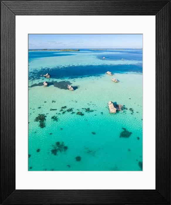 Framed Print : A bird's eye view shows a rustic Indonesian fishing village constructed on a coral reef near remote, tropical islands in the Halmahera Sea Framed Print : A bird's eye view shows a rustic Indonesian fishing village constructed on a coral reef near remote, tropical islands in the Halmahera Sea