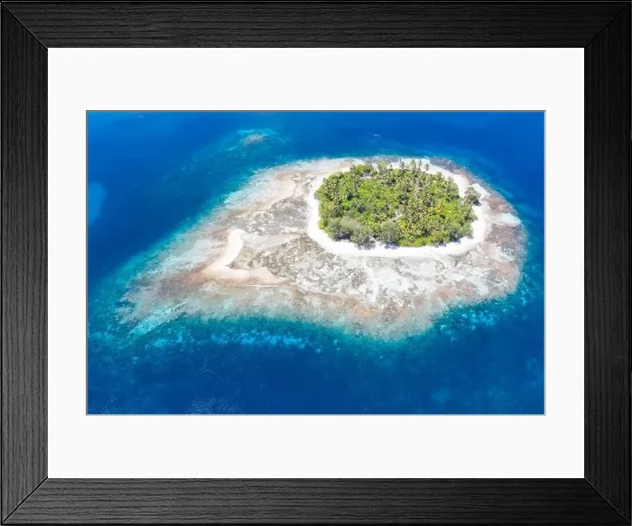 Framed Print : An idyllic tropical island is surrounded by reef in the Halmahera Sea, Indonesia. This remote region is part of the heart of the Coral Triangle Framed Print : An idyllic tropical island is surrounded by reef in the Halmahera Sea, Indonesia. This remote region is part of the heart of the Coral Triangle