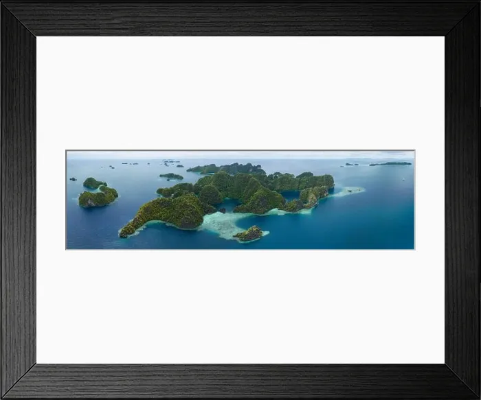 Framed Print : Coral reefs surround the rugged limestone islands that rise from Raja Ampat's seascape. This remote part of Indonesia has high marine biodiversity Framed Print : Coral reefs surround the rugged limestone islands that rise from Raja Ampat's seascape. This remote part of Indonesia has high marine biodiversity