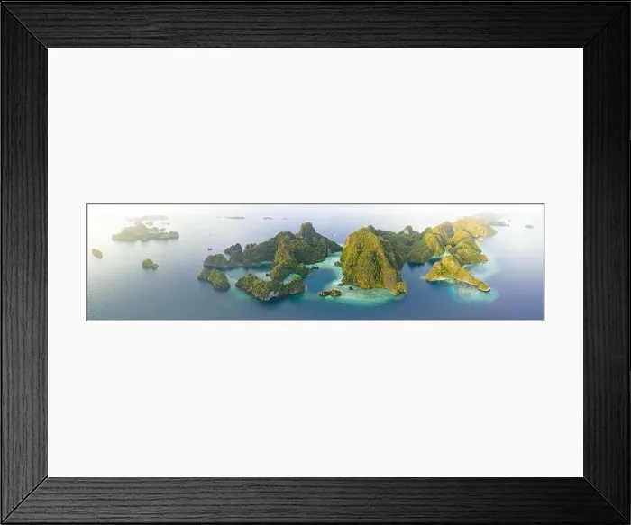 Framed Print : Coral reefs surround the rugged limestone islands that rise from Raja Ampat's seascape. This remote part of Indonesia has high marine biodiversity Framed Print : Coral reefs surround the rugged limestone islands that rise from Raja Ampat's seascape. This remote part of Indonesia has high marine biodiversity