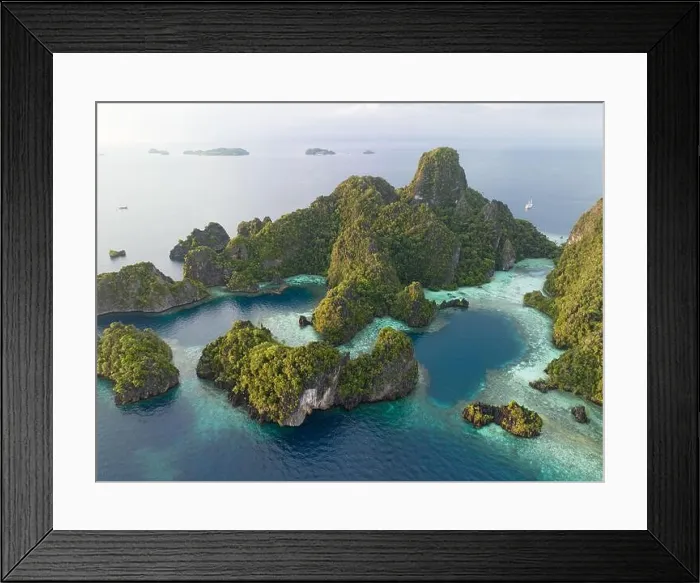 Framed Print : Coral reefs surround the dramatic limestone islands that have been uplifted from Raja Ampat's beautiful and biodiverse seascape Framed Print : Coral reefs surround the dramatic limestone islands that have been uplifted from Raja Ampat's beautiful and biodiverse seascape