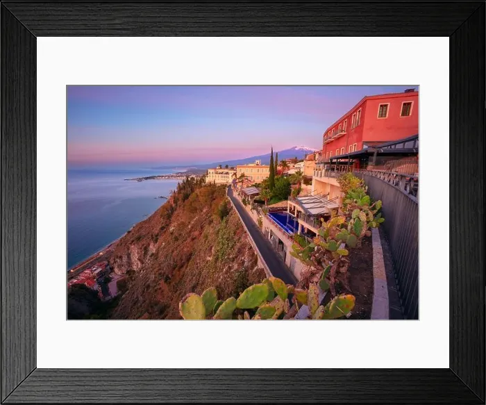 Framed Print : Taormina, Sicily, Italy. Cityscape image of picturesque town of Taormina, Sicily with volcano Mt. Etna in the background at sunrise Framed Print : Taormina, Sicily, Italy. Cityscape image of picturesque town of Taormina, Sicily with volcano Mt. Etna in the background at sunrise