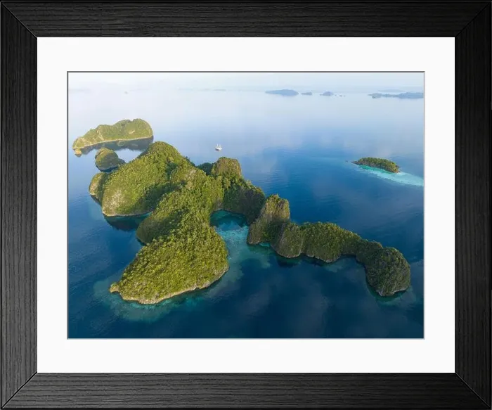 Framed Print : Coral reefs surround the dramatic limestone islands that have been uplifted from Raja Ampat's beautiful and biodiverse seascape Framed Print : Coral reefs surround the dramatic limestone islands that have been uplifted from Raja Ampat's beautiful and biodiverse seascape