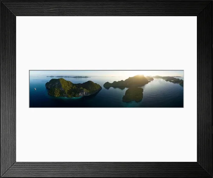 Framed Print : A peaceful sunrise illuminates dramatic limestone islands that rise from Raja Ampat's beautiful seascape. This area has high marine biodiversity Framed Print : A peaceful sunrise illuminates dramatic limestone islands that rise from Raja Ampat's beautiful seascape. This area has high marine biodiversity