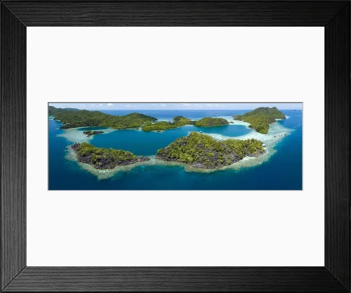Framed Print : Beautiful and diverse coral reefs surround the dramatic limestone islands that rise from Raja Ampat's varied seascape
