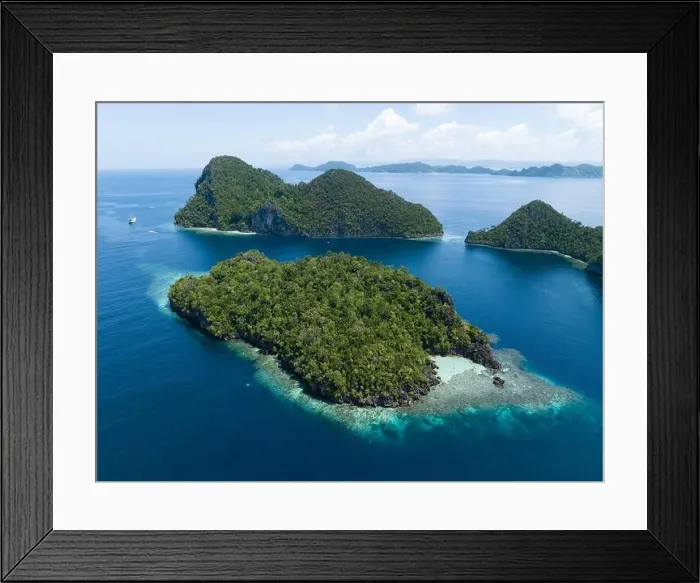 Framed Print : Beautiful and diverse coral reefs surround the dramatic limestone islands that rise from Raja Ampat's varied seascape Framed Print : Beautiful and diverse coral reefs surround the dramatic limestone islands that rise from Raja Ampat's varied seascape