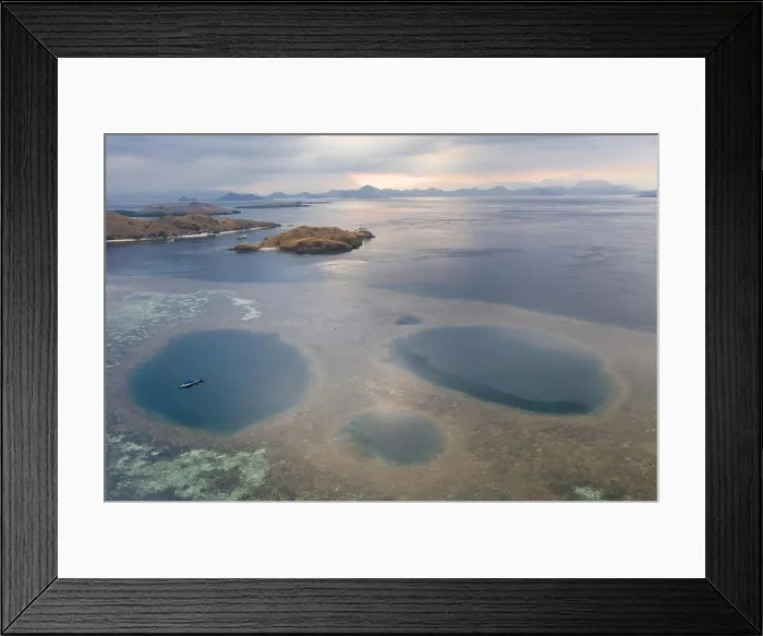 Framed Print : Blue holes are found amid a shallow reef flat on the island of Sebayor in Komodo National Park, Indonesia. These blue holes formed as sink holes Framed Print : Blue holes are found amid a shallow reef flat on the island of Sebayor in Komodo National Park, Indonesia. These blue holes formed as sink holes