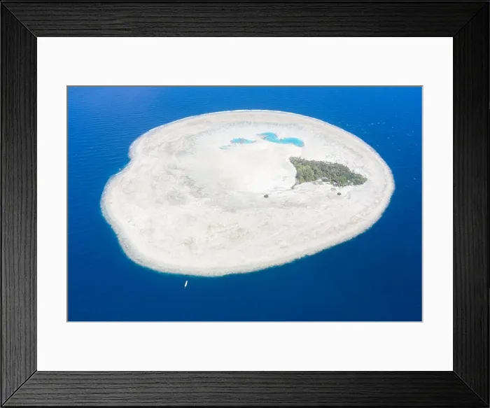 Framed Print : A Pinisi schooner drifts near the remote, tropical island of Midorang in the Ceram Sea. This area harbors extremely high marine biodiversity Framed Print : A Pinisi schooner drifts near the remote, tropical island of Midorang in the Ceram Sea. This area harbors extremely high marine biodiversity