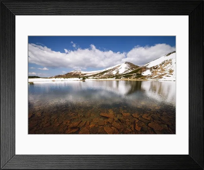 Framed Print : Picturesque spring landscape with snowy hills and clear mountain lake under a blue sky, Carpathian mountains, Europe Framed Print : Picturesque spring landscape with snowy hills and clear mountain lake under a blue sky, Carpathian mountains, Europe
