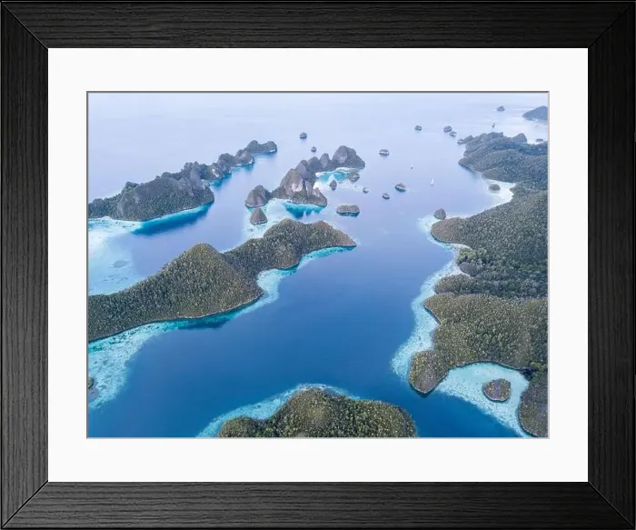 Framed Print : An amazing set of limestone islands are found in a remote part of Raja Ampat, Indonesia. These tropical islands are surrounded by healthy coral reefs Framed Print : An amazing set of limestone islands are found in a remote part of Raja Ampat, Indonesia. These tropical islands are surrounded by healthy coral reefs