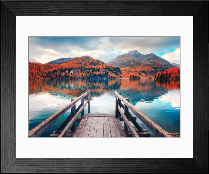 Framed Print : Wooden pier on autumn lake Sils (Silsersee) in Swiss Alps. Snowy mountains and orange trees on background Framed Print : Wooden pier on autumn lake Sils (Silsersee) in Swiss Alps. Snowy mountains and orange trees on background