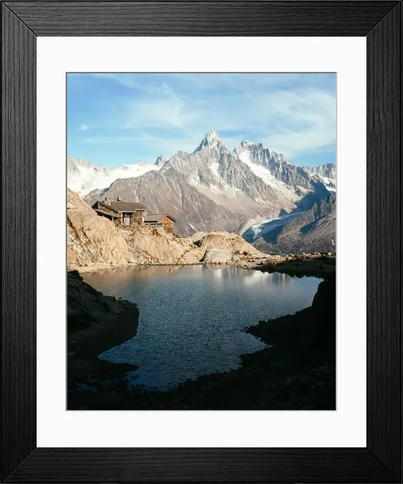 Framed Print : Wooden cabin on Lac Blanc lake coast in France Alps. Monte Bianco mountain range on background. Landscape photography, Chamonix Framed Print : Wooden cabin on Lac Blanc lake coast in France Alps. Monte Bianco mountain range on background. Landscape photography, Chamonix