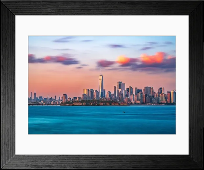 Framed Print : New York, New York, USA skyline from the harbor with Ellis Island at dusk