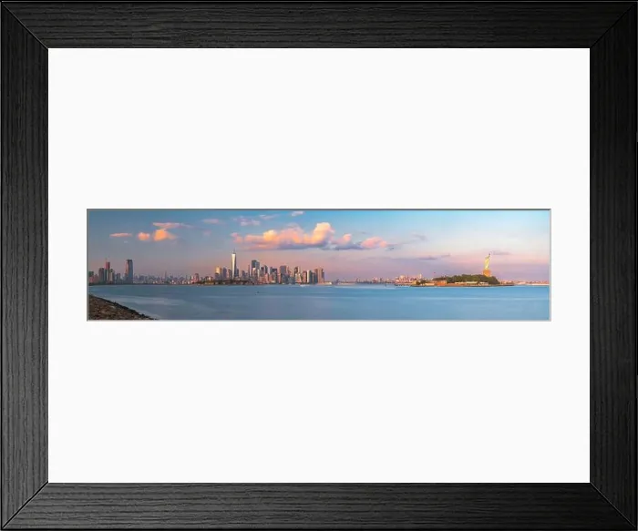 Framed Print : New York, New York, USA skyline from the harbor with Ellis Island and the Statue of Liberty at dusk Framed Print : New York, New York, USA skyline from the harbor with Ellis Island and the Statue of Liberty at dusk
