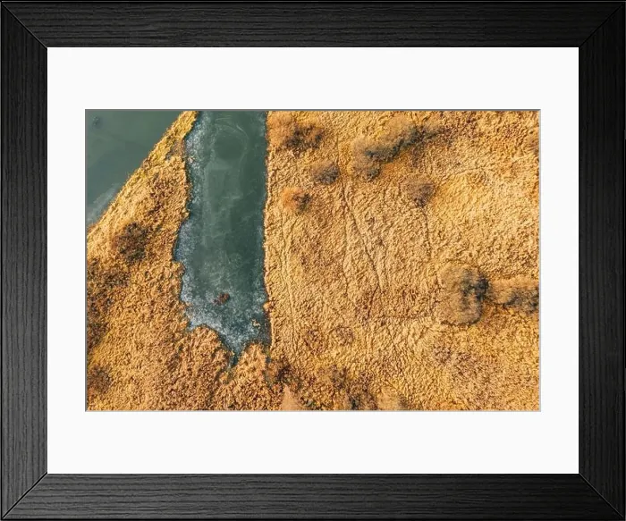 Framed Print : Aerial View Of Dry Grass And Partly Frozen River Landscape In Late Autumn Day. High Attitude View. Marsh Bog. Drone View. Bird's Eye View Framed Print : Aerial View Of Dry Grass And Partly Frozen River Landscape In Late Autumn Day. High Attitude View. Marsh Bog. Drone View. Bird's Eye View