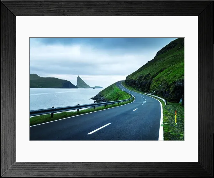 Framed Print : Dramatic evening view of the road and the Drangarnir and Tindholmur rocks in the background on the island of Vagar, Faroe Islands, Denmark Framed Print : Dramatic evening view of the road and the Drangarnir and Tindholmur rocks in the background on the island of Vagar, Faroe Islands, Denmark