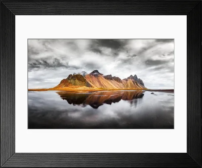 Framed Print : Incredible landscape of the famous Stokksnes mountains on Vestrahorn cape. Reflection in the clear water on the epic skies background, Iceland Framed Print : Incredible landscape of the famous Stokksnes mountains on Vestrahorn cape. Reflection in the clear water on the epic skies background, Iceland