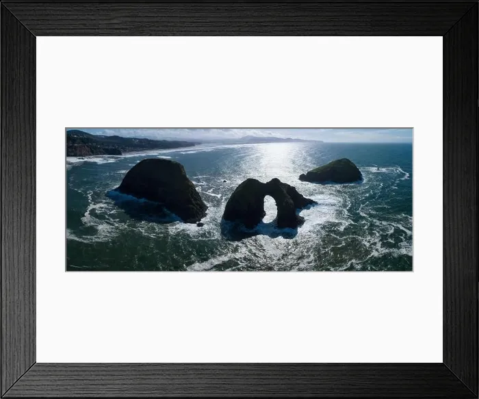 Framed Print : Sunlight shines on rugged sea stacks off the northern coast of Oregon, not far from Tillamook. This coastline has many outstanding viewpoints Framed Print : Sunlight shines on rugged sea stacks off the northern coast of Oregon, not far from Tillamook. This coastline has many outstanding viewpoints