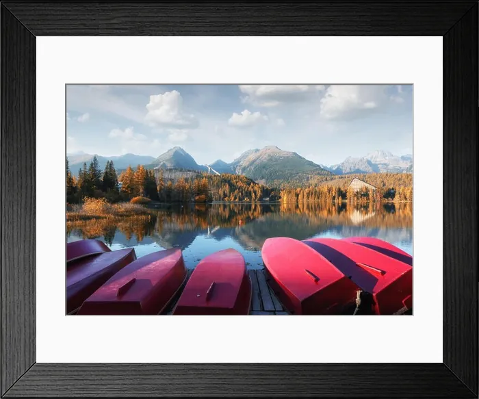 Framed Print : Picturesque autumn landscape with row of red wooden boats and high mountains on background. Strbske pleso lake in High Tatras National Park, Slovakia