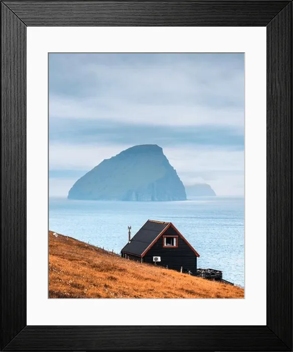 Framed Print : Black house on famous faroese Witches Finger Trail and Koltur island on background. Sandavagur village, Vagar island, Faroe islands, Denmark Framed Print : Black house on famous faroese Witches Finger Trail and Koltur island on background. Sandavagur village, Vagar island, Faroe islands, Denmark