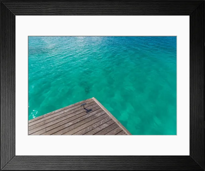 Framed Print : Jetty to a tropical beach. Edge of the water, jetty and the blue lagoon Framed Print : Jetty to a tropical beach. Edge of the water, jetty and the blue lagoon