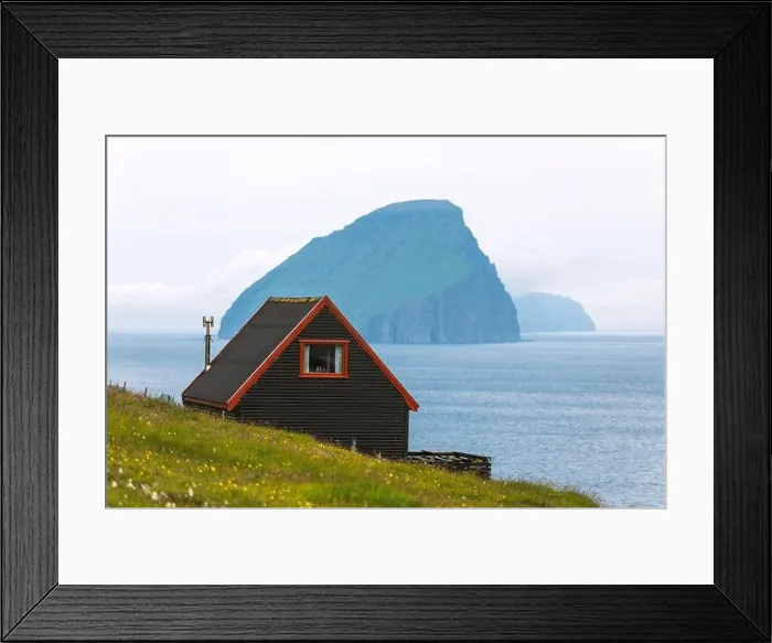 Framed Print : Black house on famous faroese Witches Finger Trail and Koltur island on background. Sandavagur village, Vagar island, Faroe islands, Denmark Framed Print : Black house on famous faroese Witches Finger Trail and Koltur island on background. Sandavagur village, Vagar island, Faroe islands, Denmark