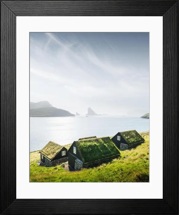 Framed Print : Picturesque view of tradicional faroese grass-covered houses in the village Bour. Drangarnir and Tindholmur sea stacks on background Framed Print : Picturesque view of tradicional faroese grass-covered houses in the village Bour. Drangarnir and Tindholmur sea stacks on background
