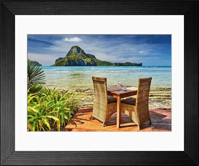 Framed Print : Outdoor terrace of the beach restaurant in front of sea with table and chairs, beautiful view to the Cadlao island, El Nido, Philippines Framed Print : Outdoor terrace of the beach restaurant in front of sea with table and chairs, beautiful view to the Cadlao island, El Nido, Philippines