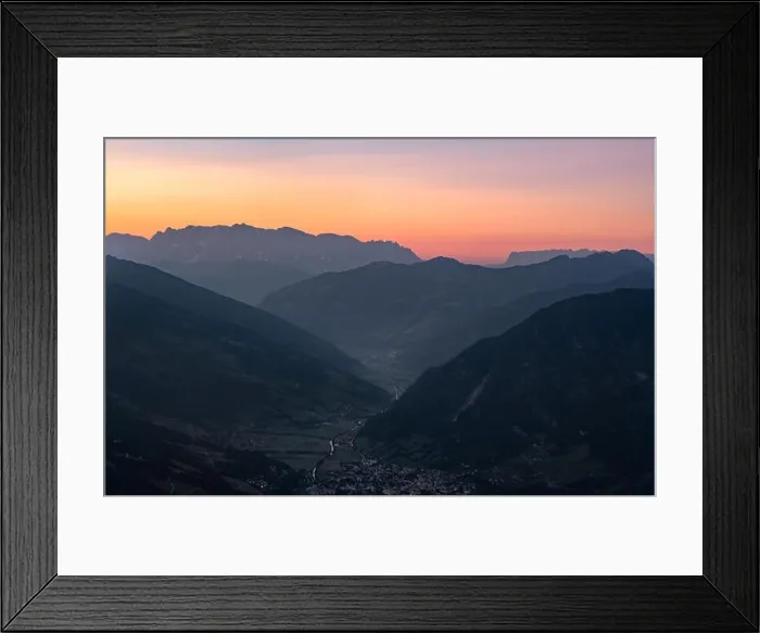 Framed Print : Scenic mountain landscape with orange sunset and idyllic valley village at summer evening in Austria alps Framed Print : Scenic mountain landscape with orange sunset and idyllic valley village at summer evening in Austria alps
