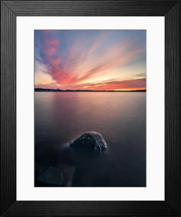 Framed Print : Scenic sunset with peaceful lake and rock at spring evening in Finland Framed Print : Scenic sunset with peaceful lake and rock at spring evening in Finland