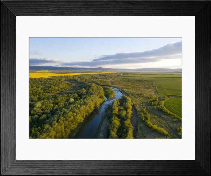 Framed Print : Flight through majestic river Dnister, lush green forest and blooming yellow rapeseed fields at sunset time. Ukraine, Europe. Landscape photography Framed Print : Flight through majestic river Dnister, lush green forest and blooming yellow rapeseed fields at sunset time. Ukraine, Europe. Landscape photography