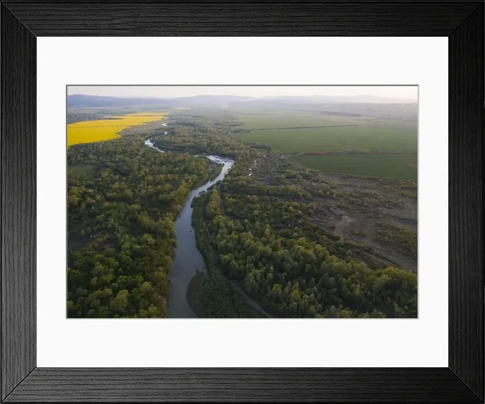 Framed Print : Flight through majestic river Dnister, lush green forest and blooming yellow rapeseed fields at sunset time. Ukraine, Europe. Landscape photography Framed Print : Flight through majestic river Dnister, lush green forest and blooming yellow rapeseed fields at sunset time. Ukraine, Europe. Landscape photography
