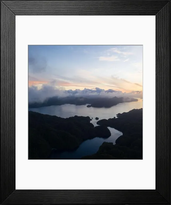 Framed Print : A narrow channel runs between beautiful limestone islands in Raja Ampat, Indonesia. This remote region is a favorite destination for scuba divers Framed Print : A narrow channel runs between beautiful limestone islands in Raja Ampat, Indonesia. This remote region is a favorite destination for scuba divers